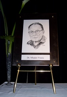 Framed portrait of Mladen Vranic  resting on table easel.